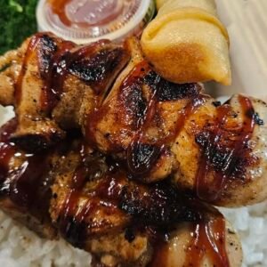Chicken skewer over rice and lumpia